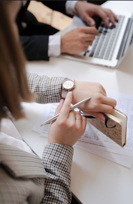 Professional planning tasks and improving productivity using a laptop and notebook